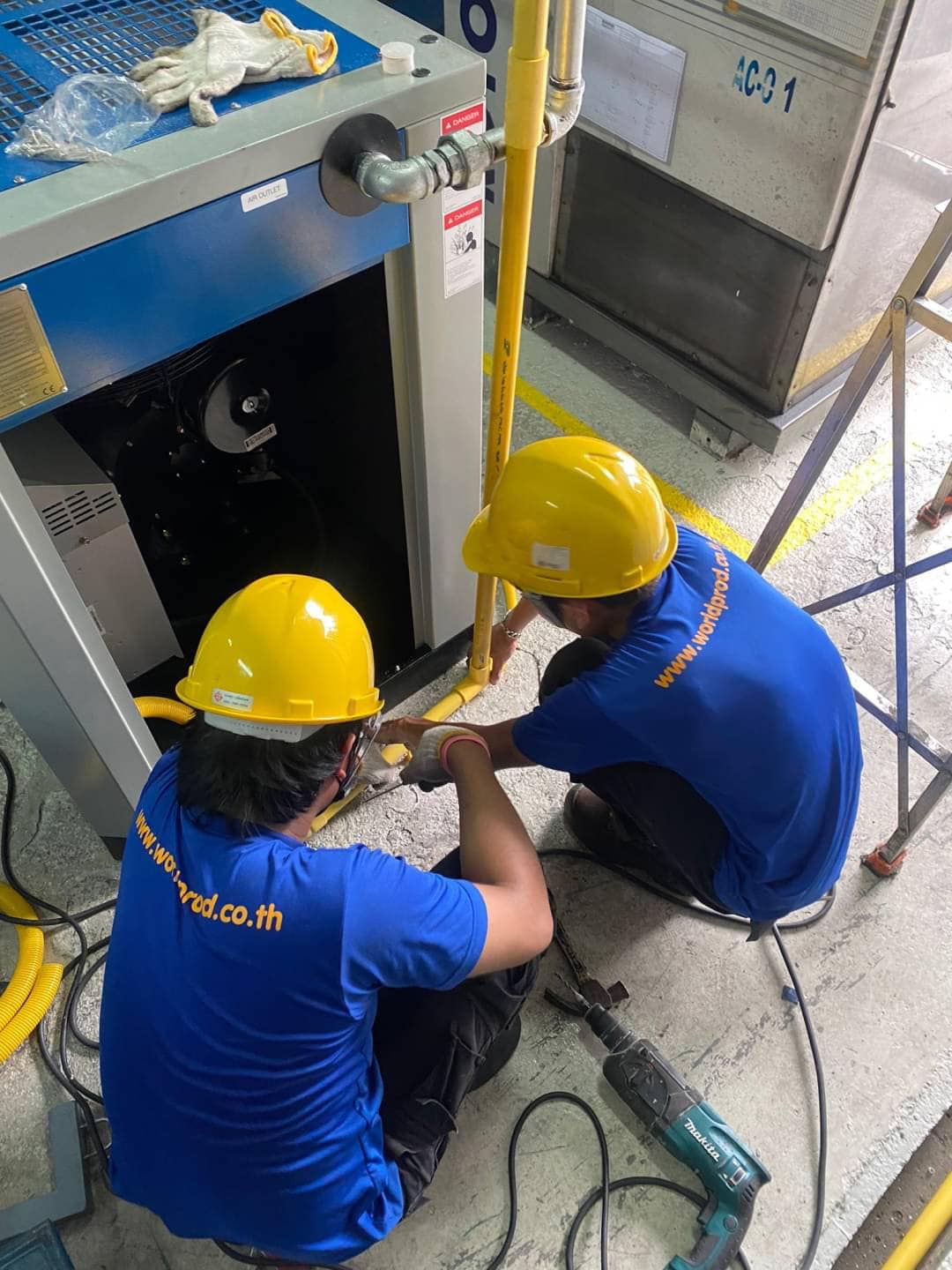 World Prod technicians installing an air compressor